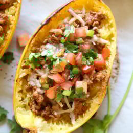 These are my favorite new way to eat spaghetti squash! Filled with the most flavorful turkey taco meat, cheese and topped with pico de gallo.