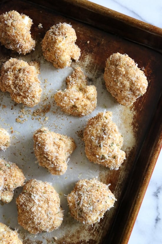 These delicious breaded cauliflower florets are baked in the oven with a parmesan-crumb crust, they remind me of my Moms fried cauliflower I used to love as a kid – without all the frying!
