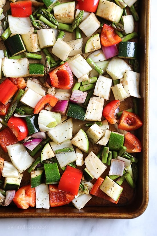 Penne baked with cheese, sauce and loaded with healthy vegetables in every bite. Roasted zucchini, red bell peppers, asparagus, red onion and fennel are tossed with balsamic and herbs then roasted for the best tasting meatless baked pasta dish EVER!