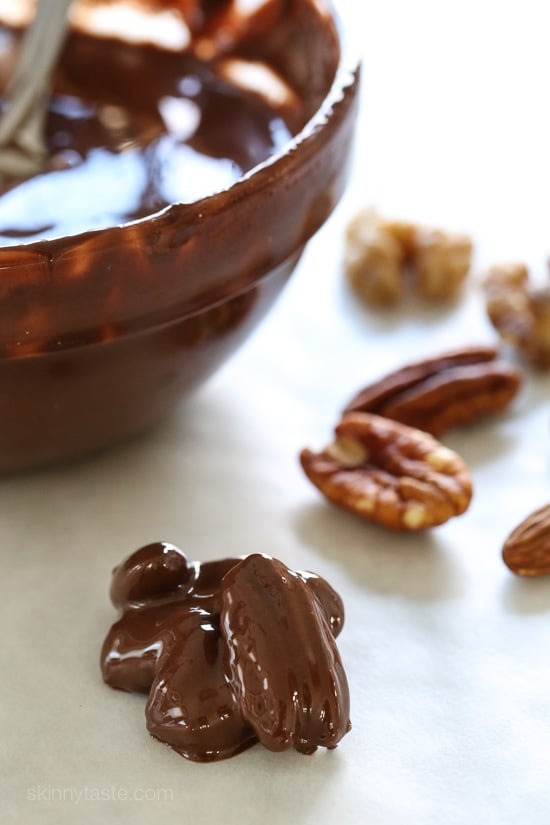 Almonds, pecans and walnuts are dipped in dark melted chocolate and finished with a touch of sea salt for the tastiest Holiday treats!