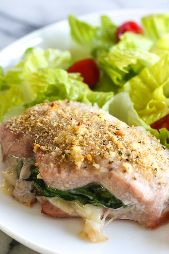 These stuffed pork chops are SO good, inspired my a meal I had at a local Italian restaurant stuffed with prosciutto, mozzarella and baby spinach then topped with garlic and breadcrumbs.