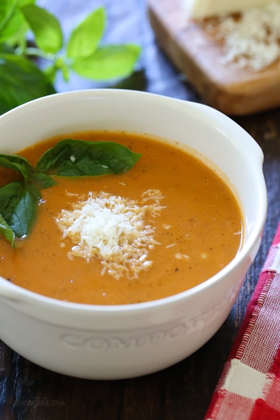 Rich and creamy, this Crockpot Tomato Soup Recipe is the perfect comfort food dish Enjoy with a sandwich or salad for an easy meal. Angled view of a bowl of creamy tomato soup