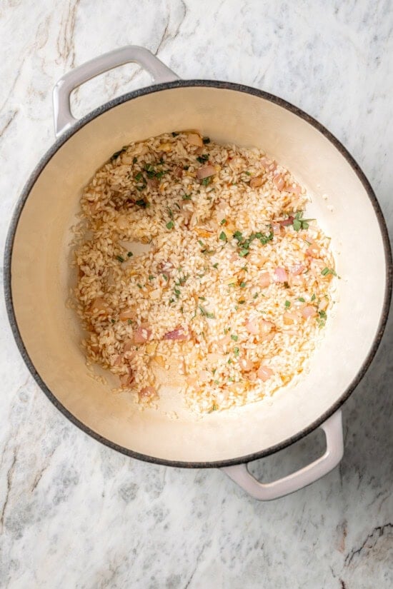 Butternut squash risotto is creamy, delicious and satisfying! It takes a little time, but it’s still easy to make—and absolutely worth it! Toasting arborio rice in pot for risotto