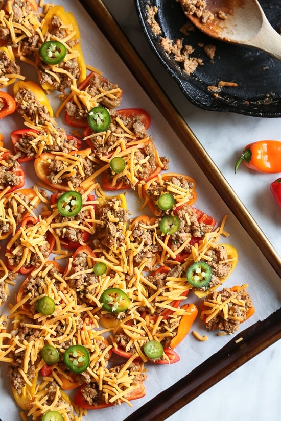 Loaded mini bell pepper nachos – game changer!! These low-carb nachos are loaded with turkey taco meat, cheese and all your favorite nacho toppings!