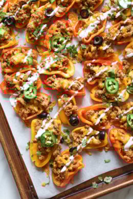 Loaded mini bell pepper nachos – game changer!! These low-carb nachos are loaded with turkey taco meat, cheese and all your favorite nacho toppings!
