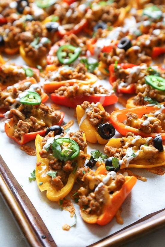 Loaded mini bell pepper nachos – game changer!! These low-carb nachos are loaded with turkey taco meat, cheese and all your favorite nacho toppings!