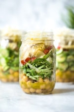 A quick and easy salad in a jar made with shaved Brussels sprouts, chickpeas, marinated artichokes, sun dried tomatoes and Asiago cheese. Perfect to pack for work or anywhere you need a portable lunch on-the-go! To serve you simply shake it up and pour it into a bowl.