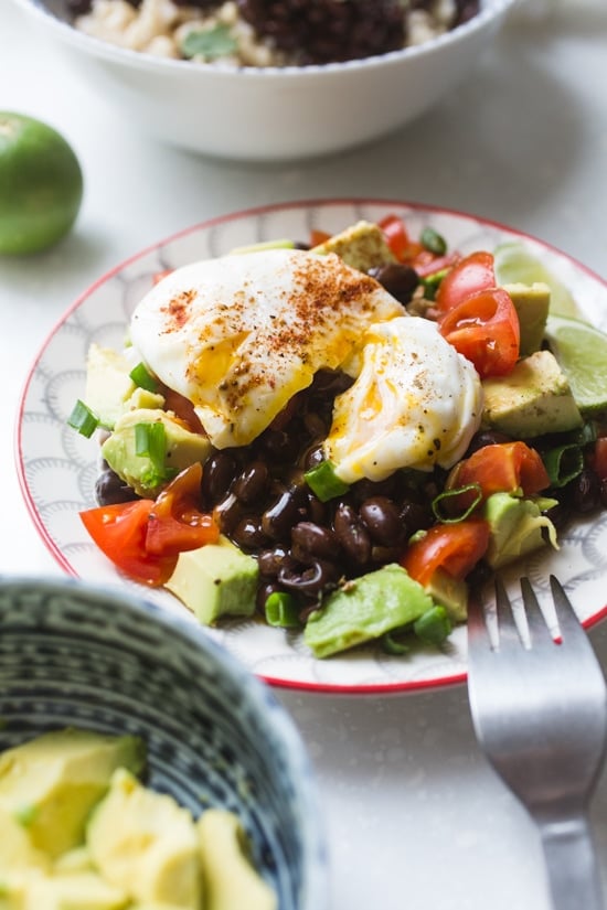 These Instant Pot Black Beans are flavored with warm spices, bacon, onion, garlic, and poblano pepper for a smoky but mild taste. Black beans with a poached egg over avocado and tomato