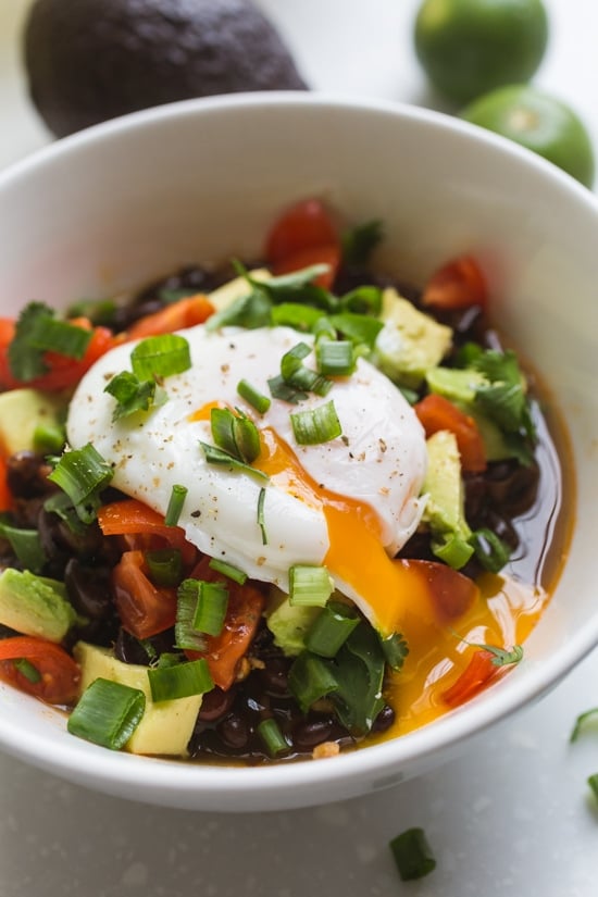These Instant Pot Black Beans are flavored with warm spices, bacon, onion, garlic, and poblano pepper for a smoky but mild taste. Instant pot black beans served with a poached egg and veggies