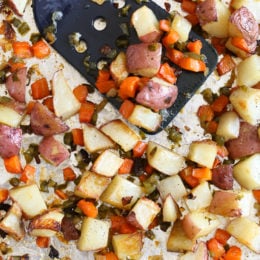 Homemade breakfast potatoes made with red potatoes, onions, bell pepper and carrots all on one sheet pan. All you need is some eggs and breakfast is served!
