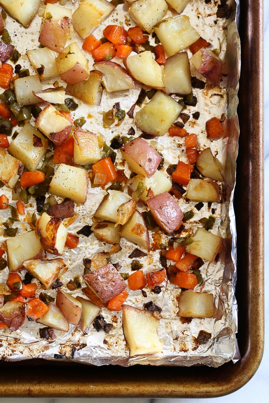 Homemade breakfast potatoes made with red potatoes, onions, bell pepper and carrots all on one sheet pan. All you need is some eggs and breakfast is served!