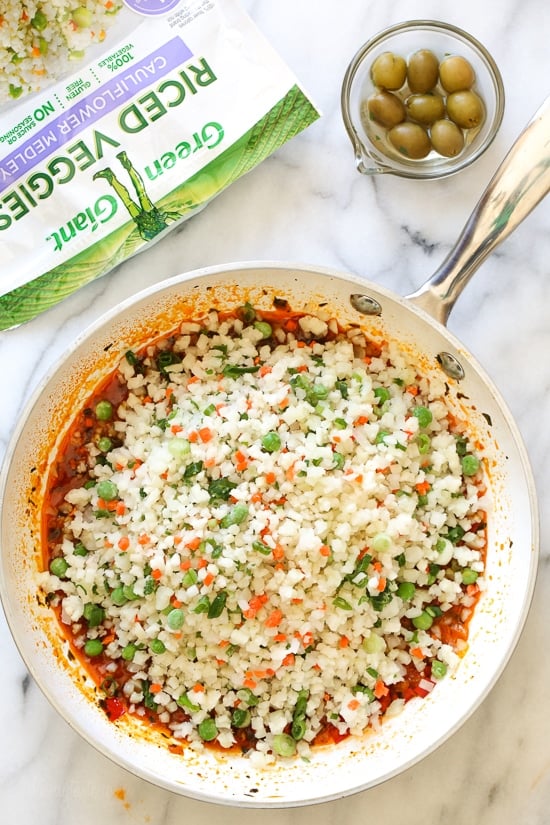 Spanish chicken and rice, a dish I grew up eating, is pure comfort food to me. This low-carb version swaps the rice for veggies, which means larger portions with 85% less calories than rice!