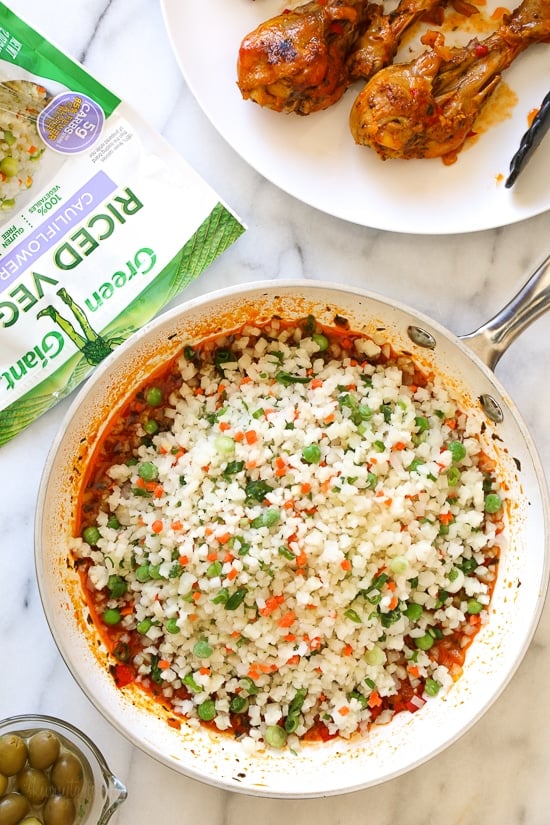 Skillet Cauliflower "Arroz" Con Pollo (Spanish chicken and rice) is a dish I grew up eating, and is pure comfort food to me. This low-carb version swaps the rice for veggies, which means larger portions with 85% less calories than rice!