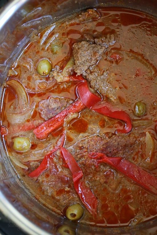 Braised Cubed Steak with Peppers, Onions and Olives is a flavorful, budget-friendly and family friendly dish you can make in the Instant Pot, Slow Cooker or in a pot on the stove.