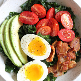 Salad for breakfast? Yes!! This Breakfast BLT Salad can be eaten anytime of the day really, but eggs and bacon served over this simple massaged kale salad with avocado and tomatoes is a delicious, savory, healthy breakfast idea.