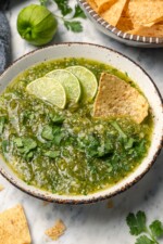 Chip dipping into bowl of homemade salsa verde