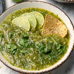 Chip dipping into bowl of homemade salsa verde