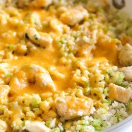 Skillet Cheesy Chicken and Veggie "Rice" made with riced broccoli and cauliflower, sauteed chicken and cheddar cheese. It's so fast and easy to make!
