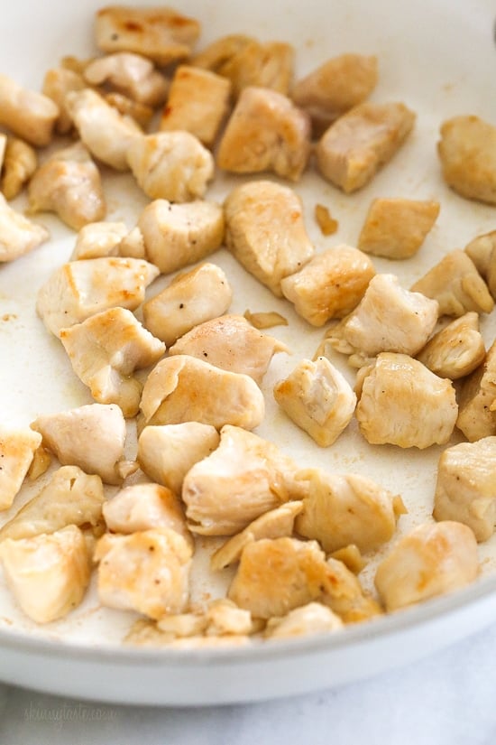 Skillet Cheesy Chicken and Veggie "Rice" made with riced broccoli and cauliflower, sauteed chicken and cheddar cheese. It's so fast and easy to make!