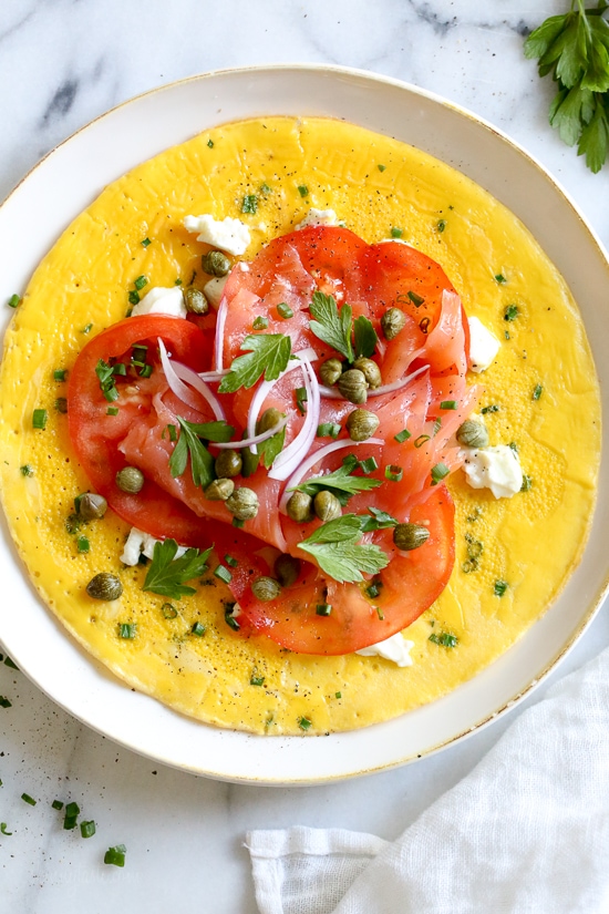This Goat Cheese Herb Omelet topped with Nova Lox, sliced tomatoes and capers satisfies my bagel-and-lox craving, without the bagel! SO quick, takes about 5 minutes to make!