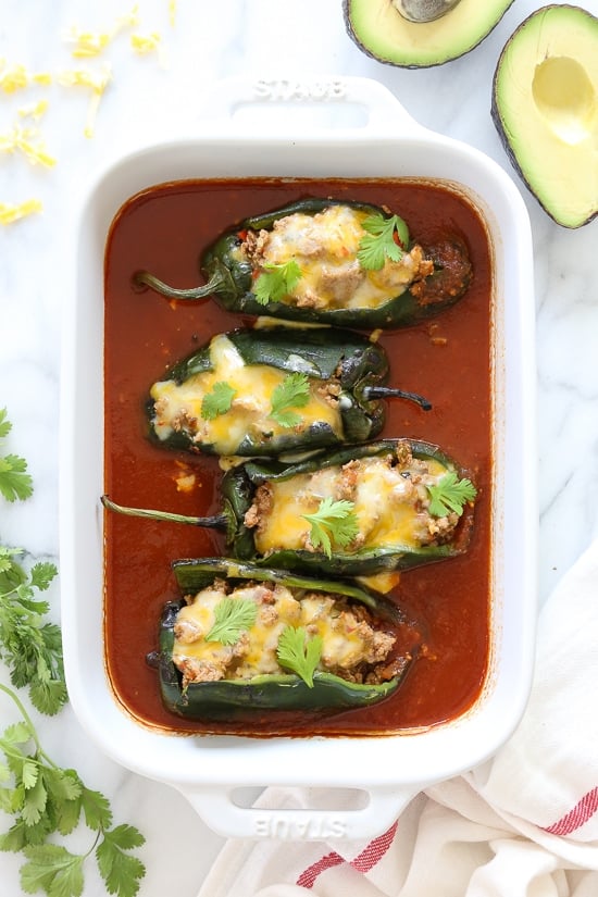 These baked Turkey Enchilada Stuffed Poblanos Rellenos are peppers stuffed with a flavorful ground turkey filling, topped with my homemade enchilada sauce and cheese.