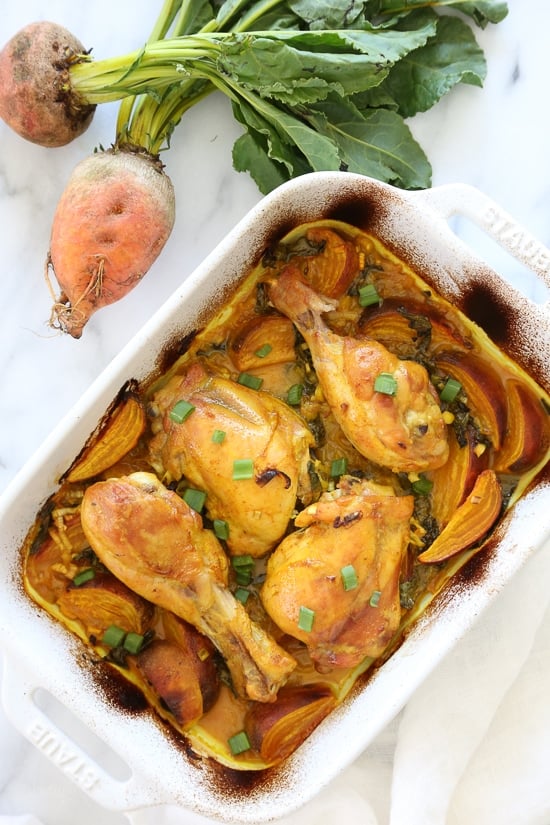 Turmeric Braised Chicken with Golden Beets and Leeks is a flavorful dish layered with vegetables and spices, covered with wine and baked in a casserole dish.