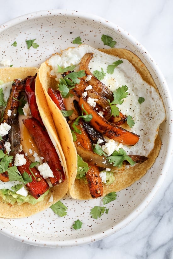 I just love tacos with eggs, and these breakfast fajitas are no exception. Loaded with peppers and onions, guacamole and a runny egg on top (you can prepare the eggs however you like).