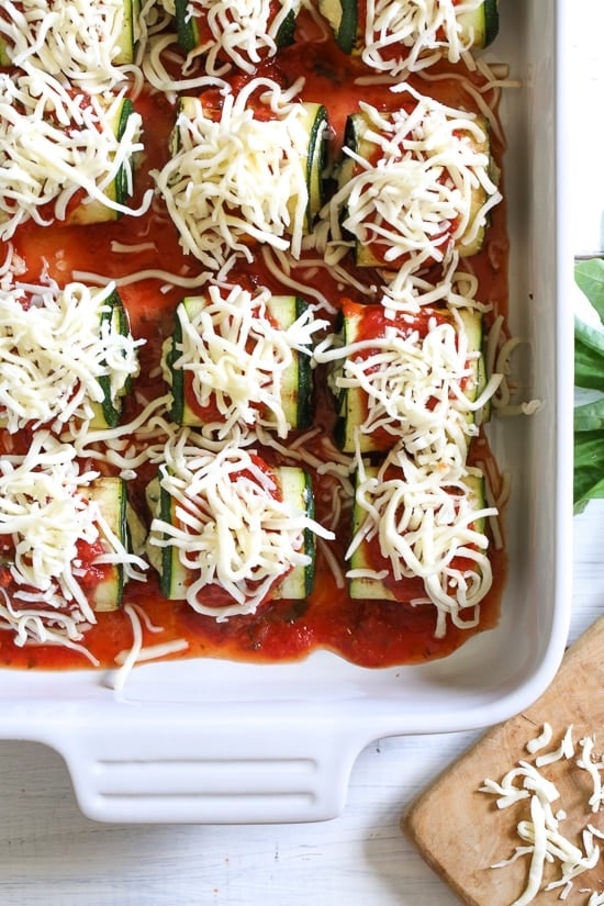 Noodle-less Zucchini Rollatini is low-carb and delicious! Made with strips of grilled zucchini stuffed with a basil-cheese filling, then rolled and topped with marinara, mozzarella and baked in the oven until the cheese is hot and melted.