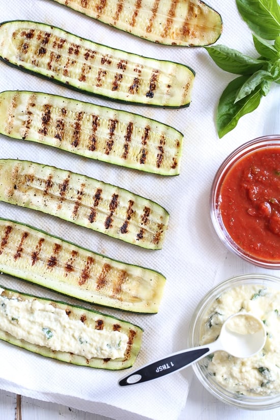 Zucchini Rollatini is low-carb and delicious! Made with strips of grilled zucchini stuffed with a basil-cheese filling, then rolled and topped with marinara, mozzarella and baked in the oven until the cheese is hot and melted.