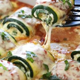 Zucchini Rollatini is low-carb and delicious! Made with strips of grilled zucchini stuffed with a basil-cheese filling, then rolled and topped with marinara, mozzarella and baked in the oven until the cheese is hot and melted.