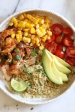 These Chipotle Chicken Bowls with Cilantro Lime Quinoa are so easy to make and have tons of flavor! I like to make them with chicken thighs but if you prefer white meat, chicken breast would work too. Extra limes for squeezing on top are recommended!
