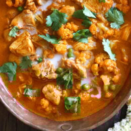 I've created a lightened up, dairy-free Chicken Tikka Masala with Cauliflower and Peas in the Instant Pot to satisfy my craving for Indian food! This mild curry is made with boneless chicken thighs cooked in a tomato base, with lots of spices and coconut milk. You can serve this with garlic naan or basmati rice on the side (cauliflower rice would work too to keep it low carb!)