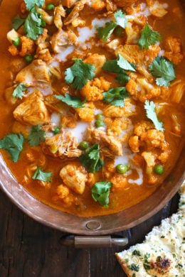 I've created a lightened up, dairy-free Chicken Tikka Masala with Cauliflower and Peas in the Instant Pot to satisfy my craving for Indian food! This mild curry is made with boneless chicken thighs cooked in a tomato base, with lots of spices and coconut milk. You can serve this with garlic naan or basmati rice on the side (cauliflower rice would work too to keep it low carb!)