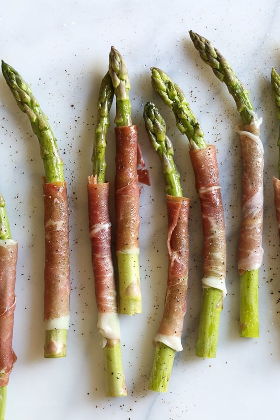 These Prosciutto Wrapped Asparagus, an easy 3-ingredient side dish, can be grilled outside or indoors if you have a grill pan. Perfect as a side dish, or as an appetizer (makes a great addition to your charcuterie platter!)