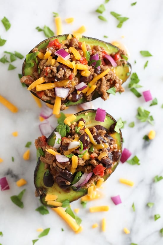 Hearty, filling, and ready in an hour, this is truly the best chili recipe! Made with beans, beef, and a blend of spices. Avocados stuffed with beef chili and topped with shredded cheese