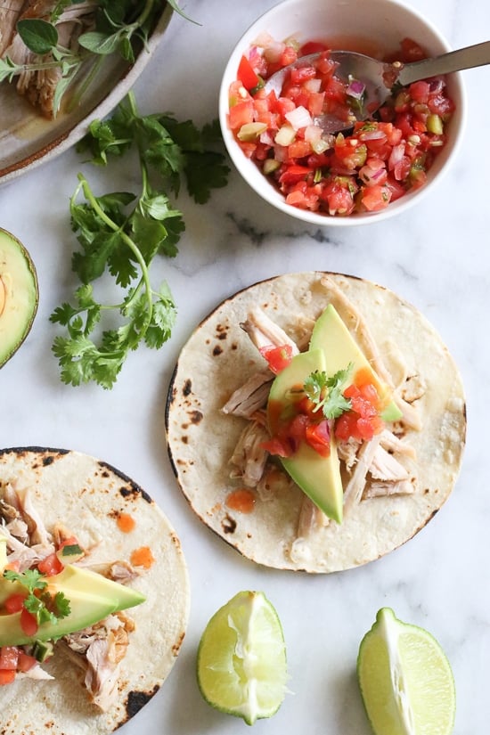 A cuban pork taco with salsa and avocado