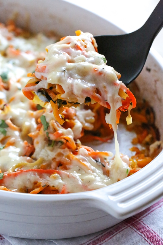 Spiralized Winter Veggie Gratin is the perfect holiday side dish! Made with spiralized vegetable gratin is made with sweet potatoes, butternut squash, carrots, and parsnips and topped with a white sauce and Gruyere cheese.