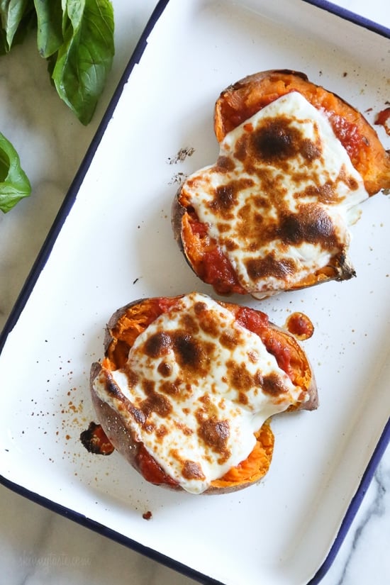 These savory stuffed sweet potatoes are topped with Italian flavors such as marinara sauce and mozzarella cheese. A quick and easy healthy vegetarian dish.