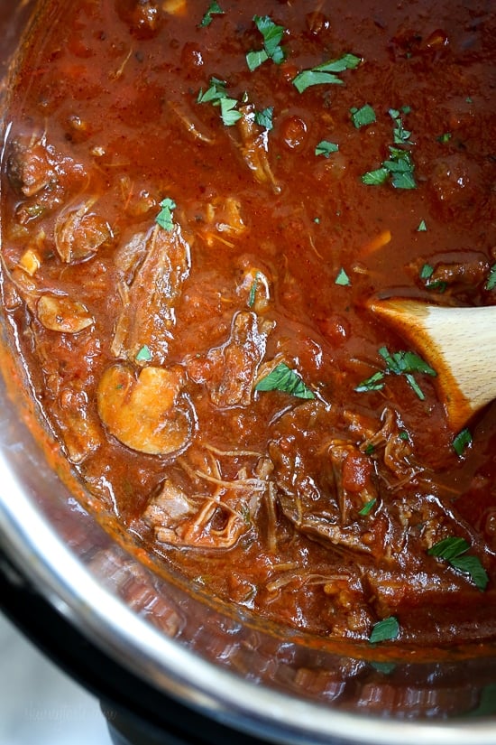 I swapped traditional pasta for roasted spaghetti squash to enjoy this cozy and delicious Beef and Mushroom Ragu served with a dollop of ricotta and grated Pecorino Romano – you won't miss the pasta!