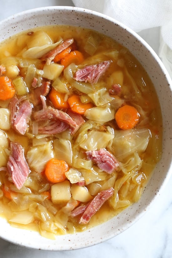 If you’re looking for leftover ham recipes, you’ll love this leftover ham bone and potato soup! It’s hearty, flavorful, and easy to make too. Bowl of leftover ham bone soup with potatoes and cabbage