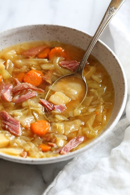 If you’re looking for leftover ham recipes, you’ll love this leftover ham bone and potato soup! It’s hearty, flavorful, and easy to make too. Bowl of ham bone soup with potatoes and cabbage
