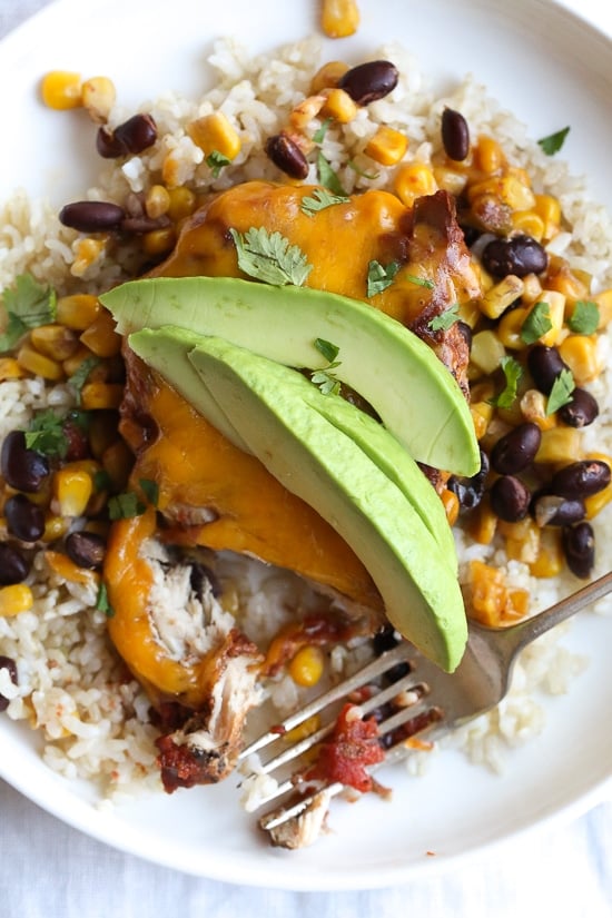 This EASY Slow Cooker Chicken dish is cheesy and delicious, made with boneless chicken breast, black beans, corn and salsa topped with melted cheddar cheese. YUM!