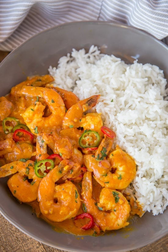 Indian Shrimp Curry made with coconut milk, tomato sauce and warm Indian spices is a quick 20 minute curry dish you can enjoy any day of the week! Indian Shrimp Curry in bowl with rice.