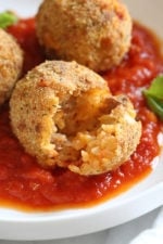 These Italian Cauliflower Rice Balls (Arancini) are made with cauliflower in place of rice! Lower in carbs and baked or made in the air fryer!