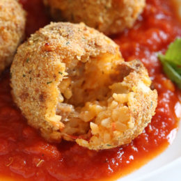These Italian Cauliflower Rice Balls (Arancini) are made with cauliflower in place of rice! Lower in carbs and baked or made in the air fryer!