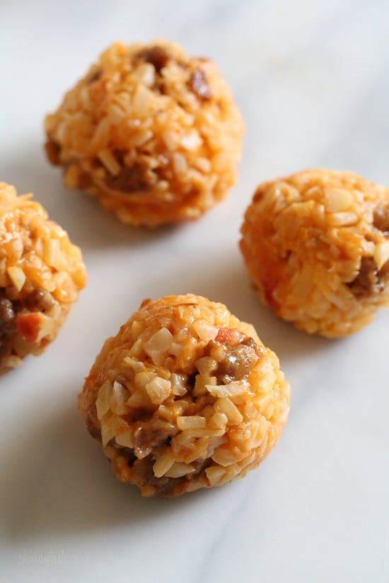 These Italian Cauliflower Rice Balls (Arancini) are made with cauliflower in place of rice! Lower in carbs and baked or made in the air fryer!