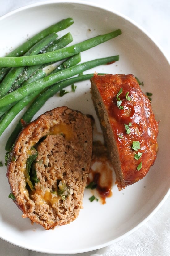 The best tasting, moist turkey meatloaf stuffed with cheddar cheese, spinach and rolled, jelly roll style topped with a ketchup based glaze. 
