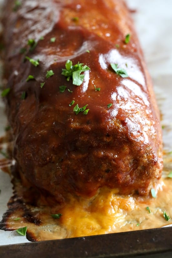 The best tasting, moist turkey meatloaf stuffed with cheddar cheese, spinach and rolled, jelly roll style topped with a ketchup based glaze. 