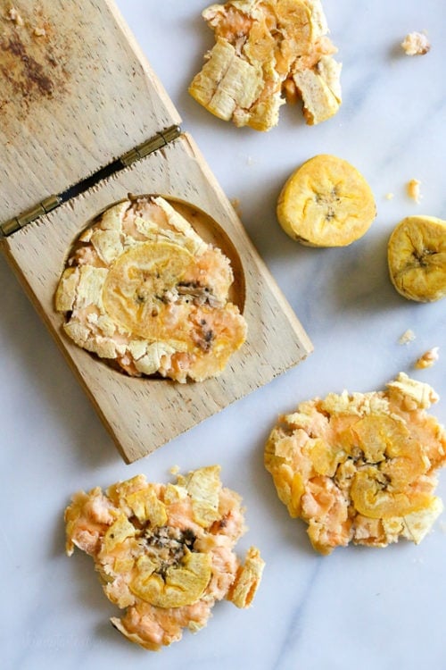 Plantains mashed with a tostonera to make tostones