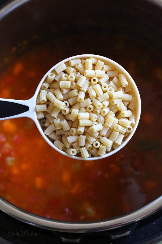 Instant Pot Turkey Meatball Soup is loaded with mini turkey meatball, zucchini, vegetables, and ditalini pasta. Hearty and healthy! A cup of ditalini held over turkey meatball soup